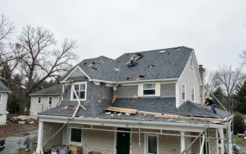 Roofing crew replacing shingles on a Buffalo home